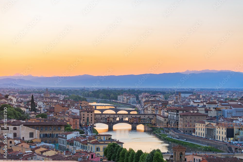 Cityscape view at Florence in evening light with  Ponte vecchio bridge over Arno river