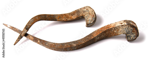 Antique forged nails are isolated on a white background.