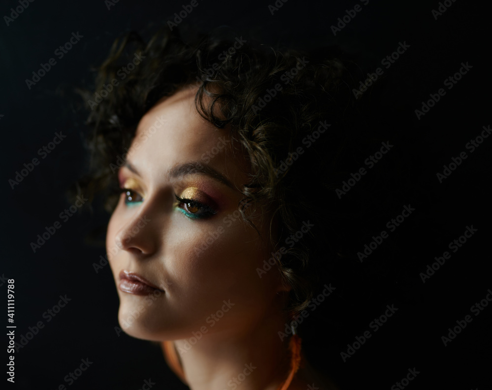 Profile portrait of young woman with bright make up