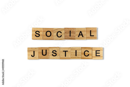 Top view of the word social justice laid out from square wooden tiles isolated on white background. World and international day.