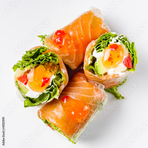 appetizing spring rolls with sea food and philadelphia cheese on a white background