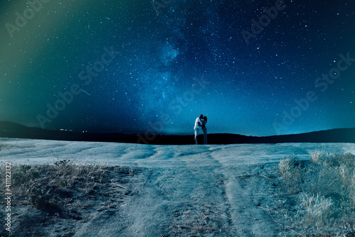 Couple kissing under amazing sky