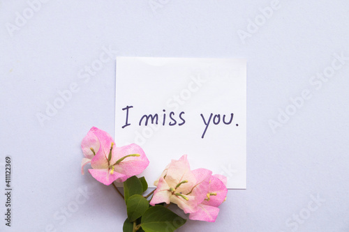 i miss you message card with pink flower bougainvillea arrangement flat lay postcard style on background white