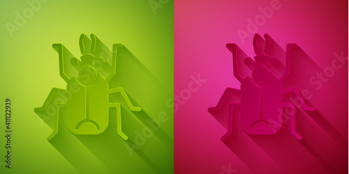 Paper cut Beetle bug icon isolated on green and pink background. Paper art style. Vector.