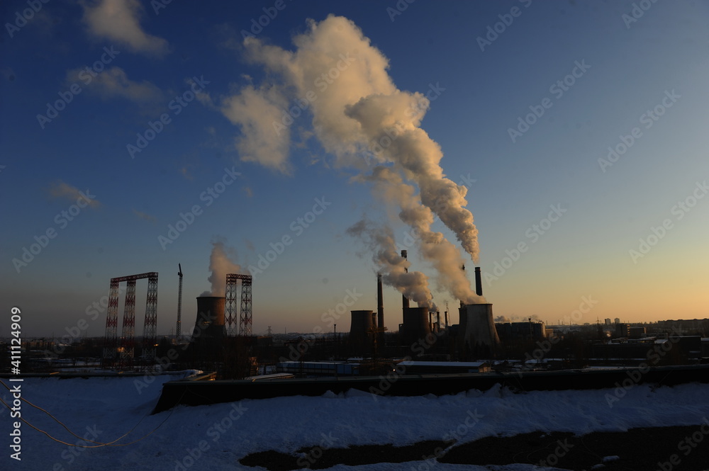 The chimney of a thermal power plant, the smoke extracted by a thermal power plant on the chimney, in the production process. Environment. Pollution.
