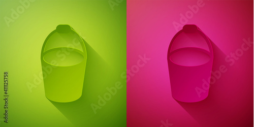 Paper cut Fire bucket icon isolated on green and pink background. Metal bucket empty or with water for fire fighting. Paper art style. Vector.