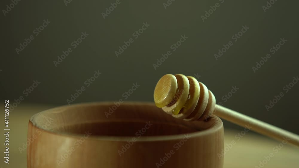 wooden bowl. Close-up. Healthy organic, wooden honey spoon, closeup. wooden bowl. Close-up. Healthy organic, wooden honey spoon, closeup.