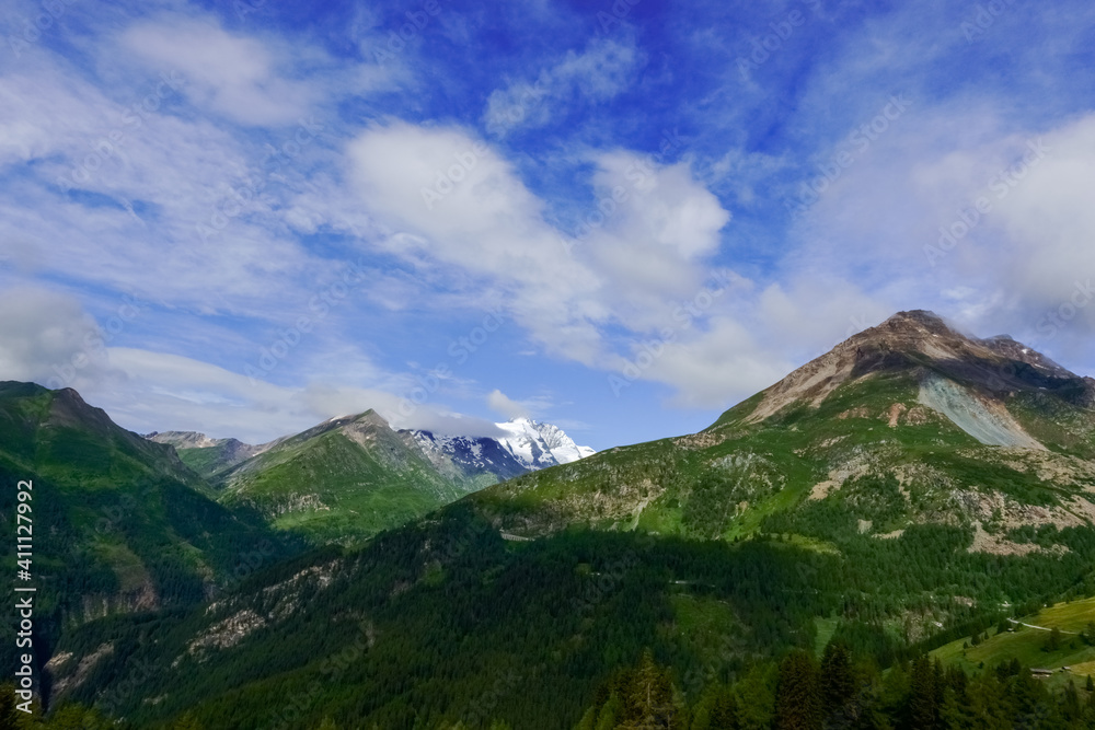 wonderful blue sky with soft clouds in green mountains