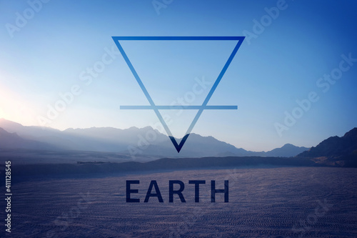 Double exposure of desert landscape and alchemical symbol of Earth photo