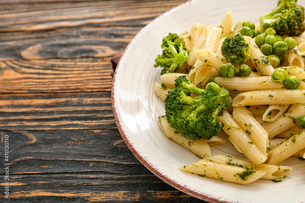 Tasty pasta with vegetables on wooden background, closeup Tasty pasta with vegetables on wooden background, closeup