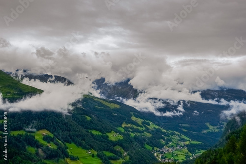 wonderful green mountain valley with dense fog and grey clouds
