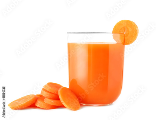 Glass of fresh carrot juice and carrot slices on white background