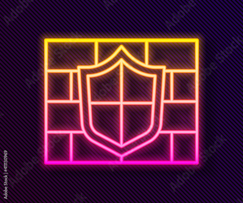 Glowing neon line Shield with cyber security brick wall icon isolated on black background. Data protection symbol. Firewall. Network protection. Vector.