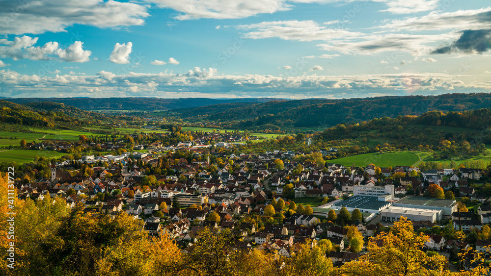 Germany, Aerial wide view above houses of city rudersberg in wieslauf valley surrounded by swabian forest nature landscape in autumn