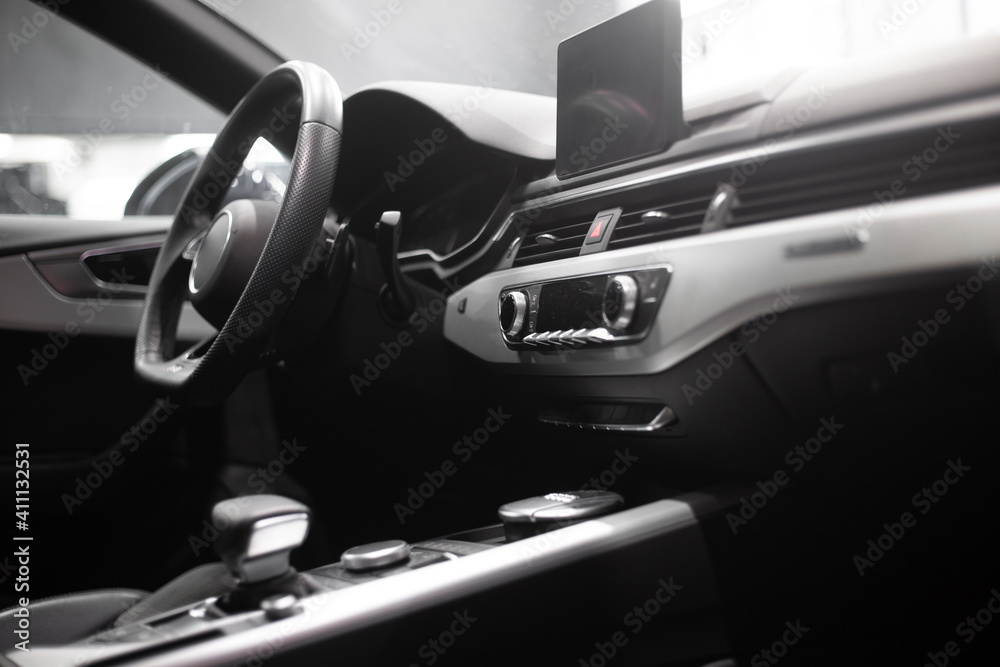 interior of a modern car. Steering wheel, seat, radio, screen.