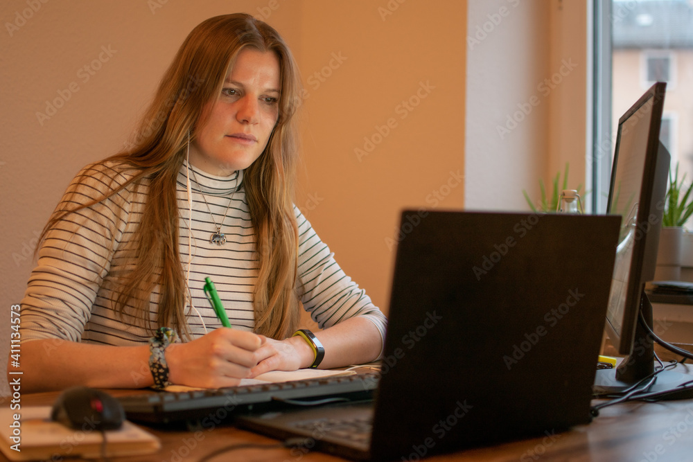 Businesswoman working on laptop computer sitting at home and managing her business via home office during Coronavirus or Covid-19 quarantine Businesswoman working on laptop computer sitting at home and managing her business via home office during Coronavirus or Covid-19 quarantine
