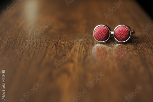 Detail of buttons placed on a solid wood surface.