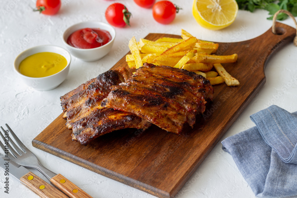 Barbecue ribs with French fries. American cuisine. Grill. Bbq.