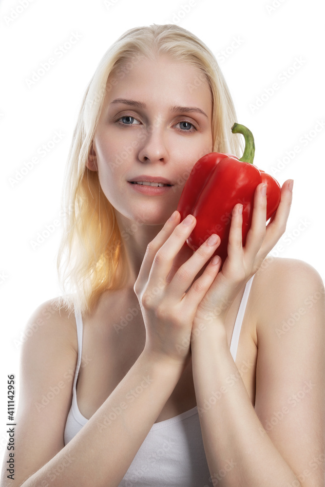 Portrait of a funny young woman holding ball pepper at her face isolated over white background Portrait of a funny young woman holding ball pepper at her face isolated over white background