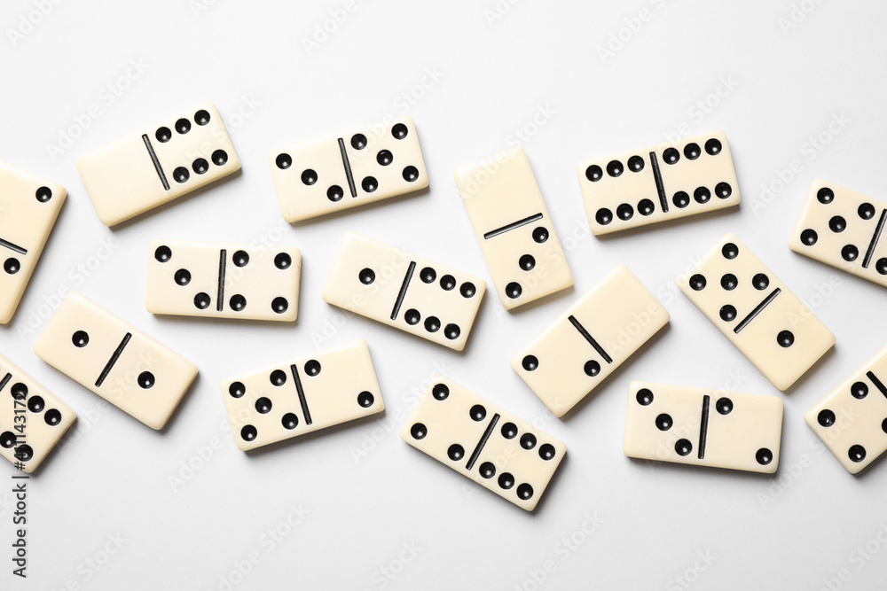 Classic domino tiles on white background, flat lay Classic domino tiles on white background, flat lay