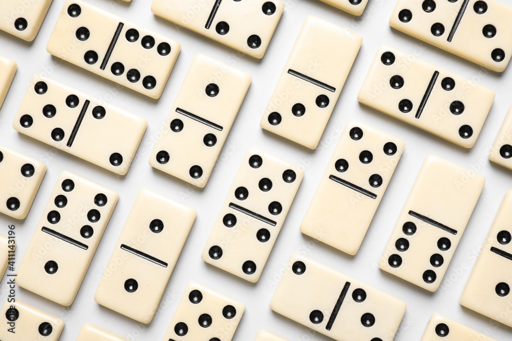 Classic domino tiles on white background, flat lay Classic domino tiles on white background, flat lay