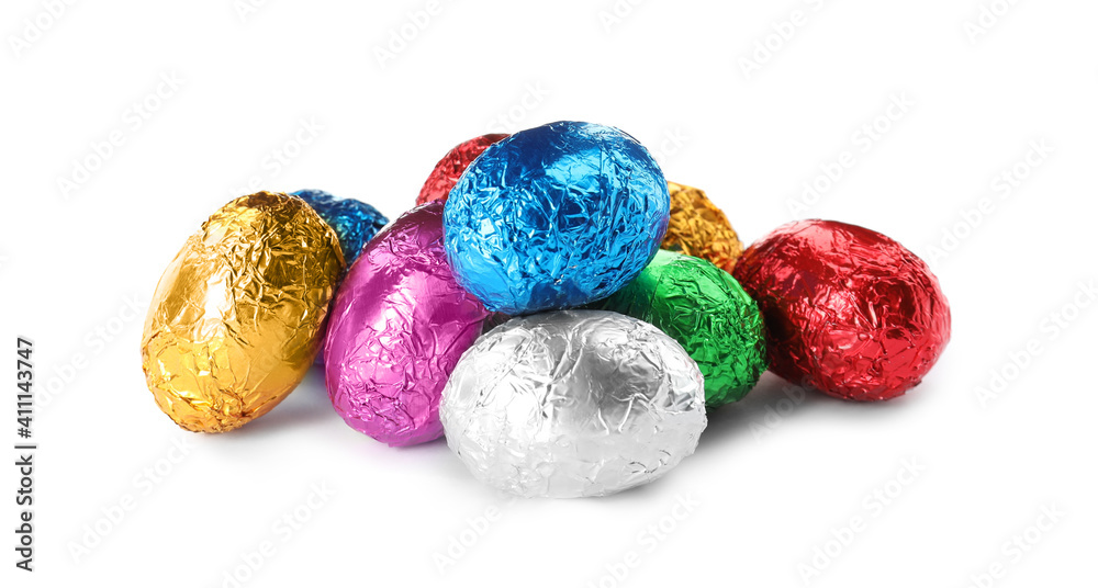 Chocolate eggs wrapped in colorful foil on white background Chocolate eggs wrapped in colorful foil on white background