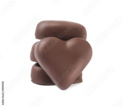 Beautiful heart shaped chocolate candies stacked on white background