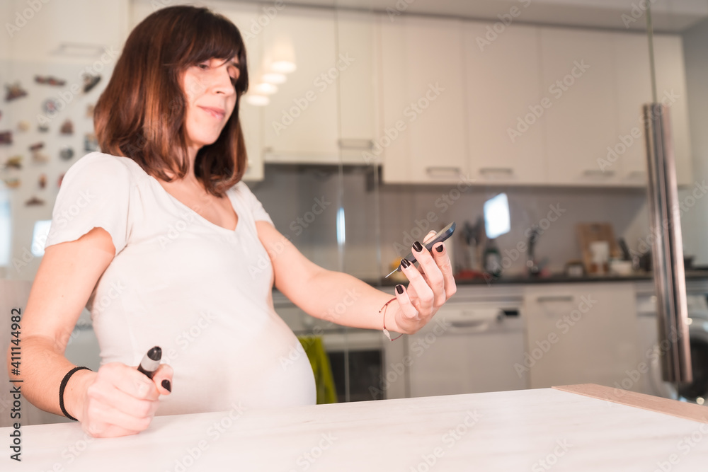 Young pregnant woman with gestational diabetes self-test to control sugar, pregnancy difficulties Young pregnant woman with gestational diabetes self-test to control sugar, pregnancy difficulties