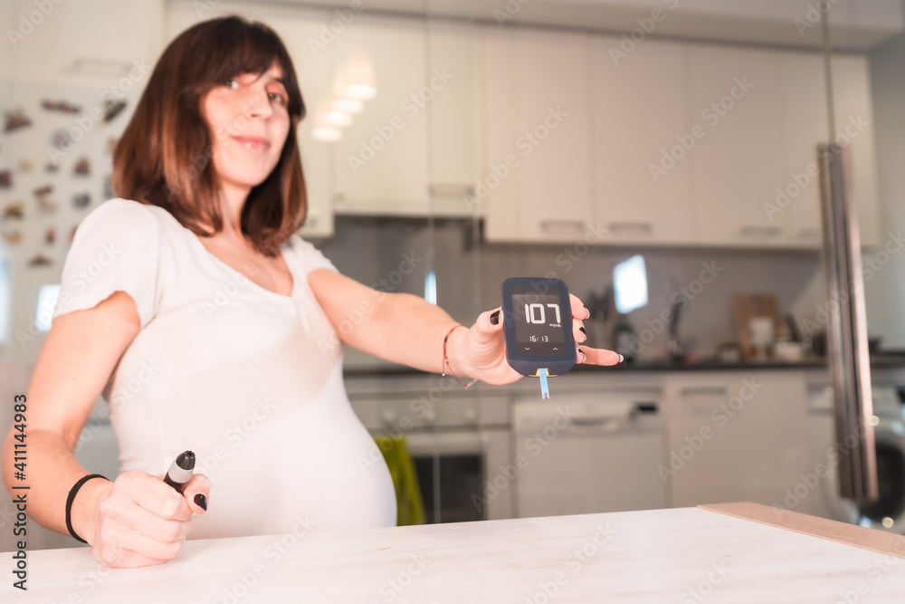 Young pregnant woman with gestational diabetes self-test to control sugar, pregnancy difficulties Young pregnant woman with gestational diabetes self-test to control sugar, pregnancy difficulties