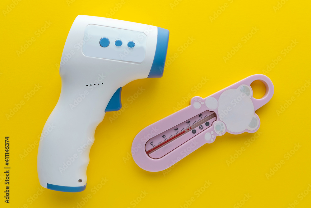 infrared non-contact and mercury thermometers for children on a yellow background
