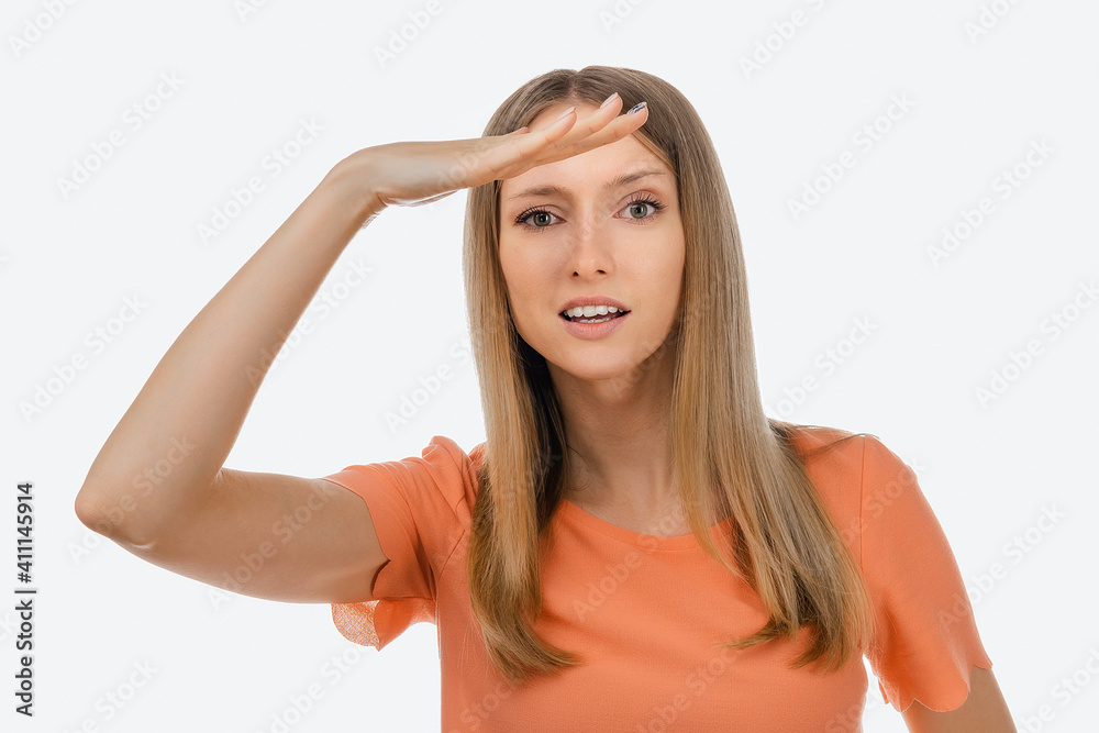 Portrait of a curious blond girl looking far away with hand at her forehead, trying to see something far away Portrait of a curious blond girl looking far away with hand at her forehead, trying to see something far away
