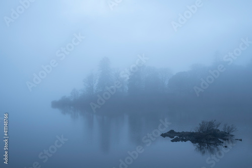 Stunning landscape image of misty Derwentwater in Lake District on cold Winter morning © veneratio
