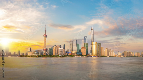 Shanghai city skyline Pudong side looking through Huangpu river on a sunny day. Shanghai, Chima. Beutiful vibrant panoramic image. © tanarch