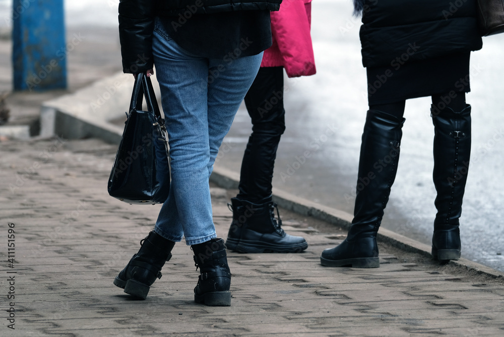 Legs of a girl standing on the sidewalk Legs of a girl standing on the sidewalk