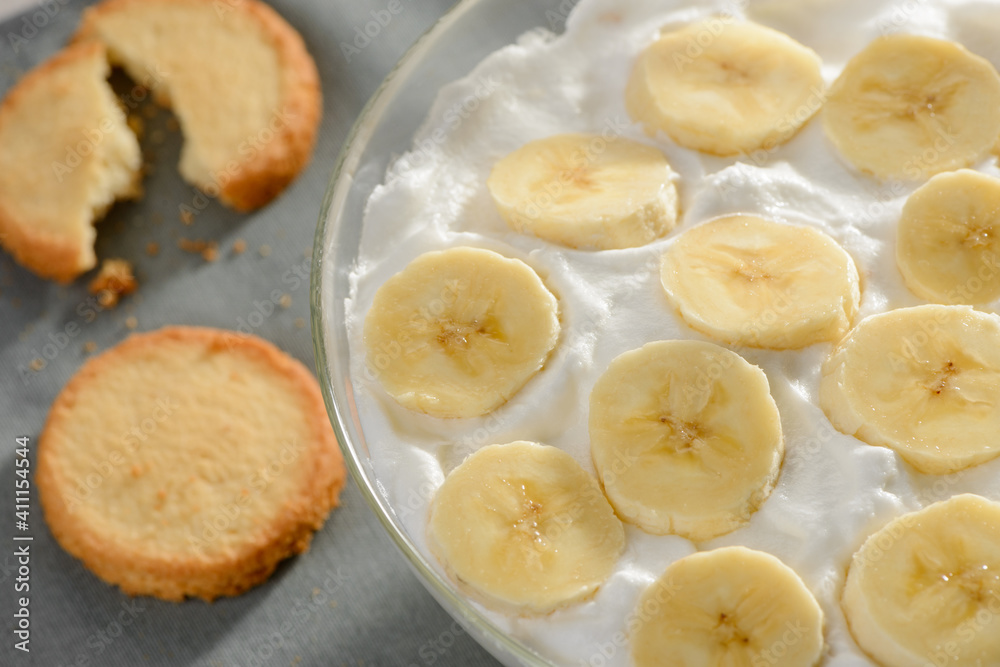 Closeup on whipped heavy cream with banana and cookies