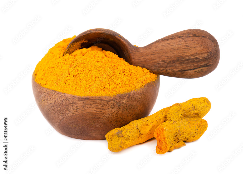 Dry turmeric powder in wooden bowl and spoon, isolated on white background. Curcuma longa linn. Dry turmeric powder in wooden bowl and spoon, isolated on white background. Curcuma longa linn.