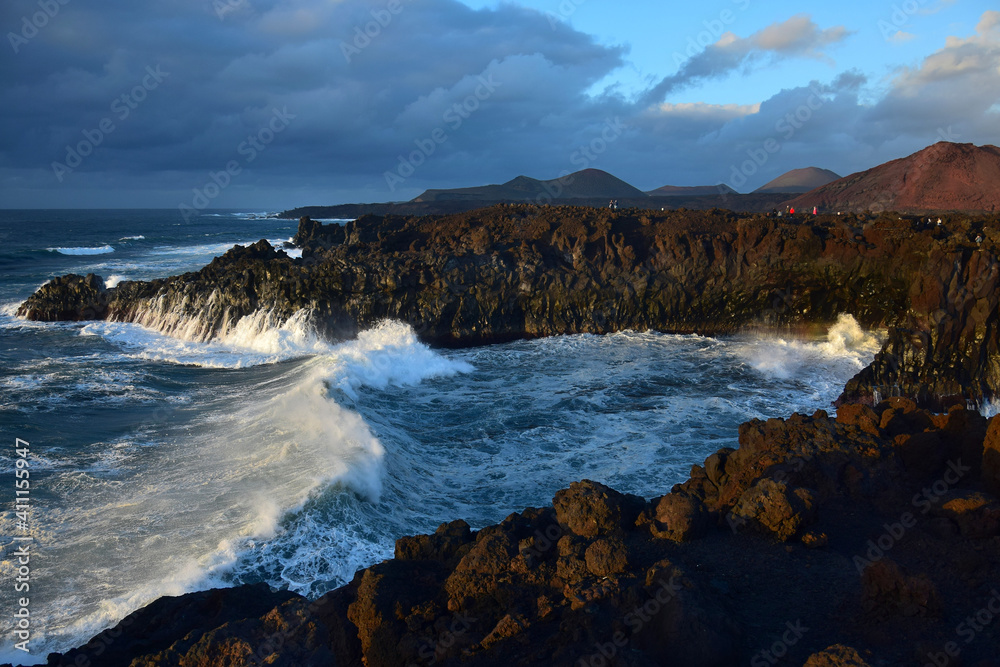 High waves at Los Hervideros in the evening sun. West coast of Lanzarote, Spain.