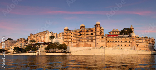 Panoramic view of the Udaipur City Palace from lake Pichola in Rajasthan, India