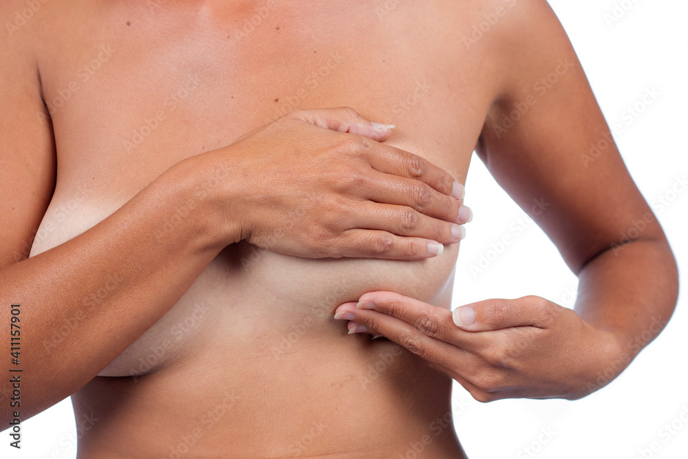 woman performs self exam on breast woman performs self exam on breast