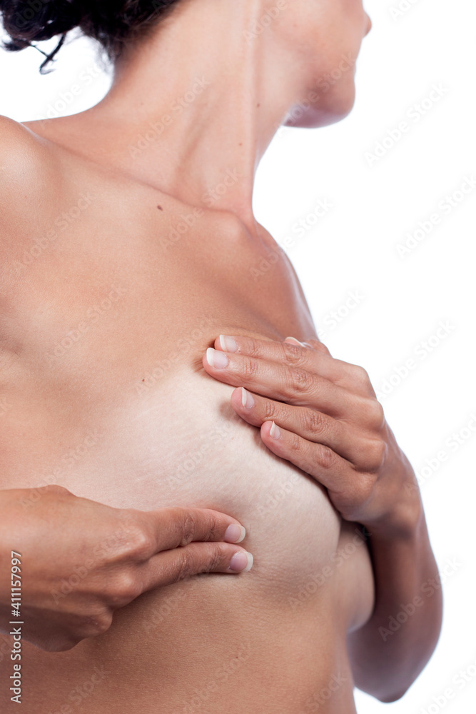 woman performs self exam on breast
