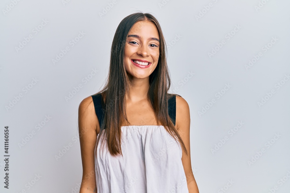 Young hispanic woman wearing casual clothes looking positive and happy standing and smiling with a confident smile showing teeth Young hispanic woman wearing casual clothes looking positive and happy standing and smiling with a confident smile showing teeth