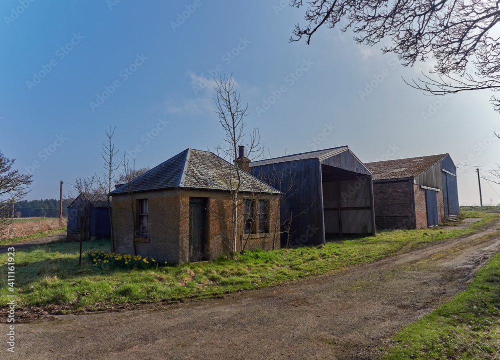 A Tiny Farm Cottage lies besides 2 Farm Barns along a Farm Track in the Angus Countryside, near Mildens in Forfar, Scotland.