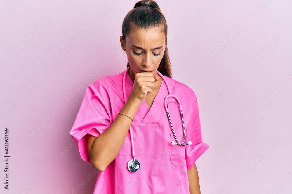 Young hispanic woman wearing doctor uniform and stethoscope feeling unwell and coughing as symptom for cold or bronchitis. health care concept. Young hispanic woman wearing doctor uniform and stethoscope feeling unwell and coughing as symptom for cold or bronchitis. health care concept.