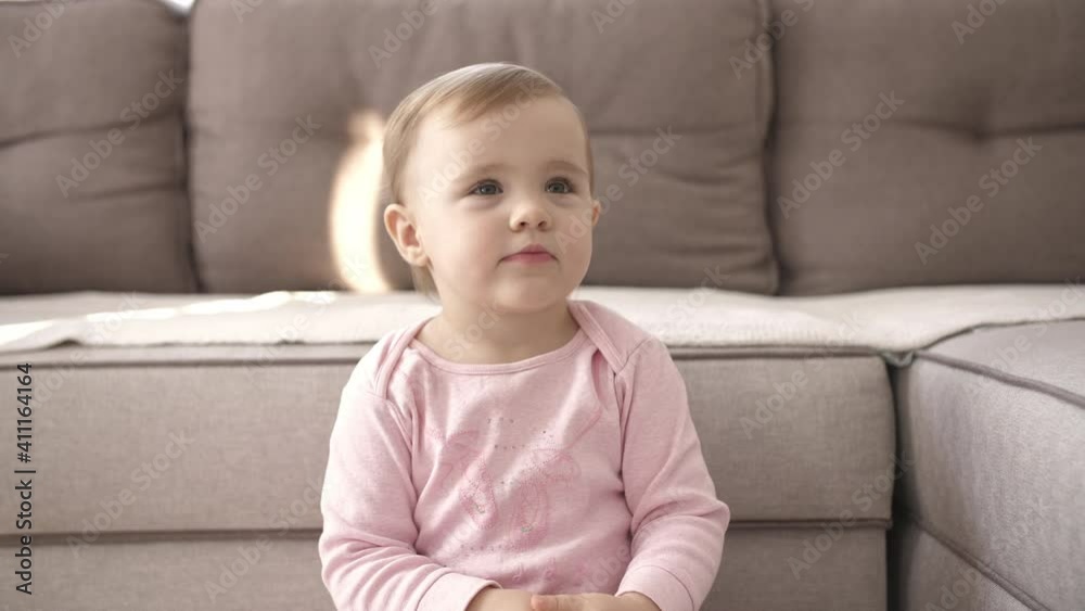 Portrait cute little kid while watching TV. Young girl watch television on living room. Concept video entertainment, emotions, family. child watching TV, close up face of little girl, kid eyes. Portrait cute little kid while watching TV. Young girl watch television on living room. Concept video entertainment, emotions, family. child watching TV, close up face of little girl, kid eyes.