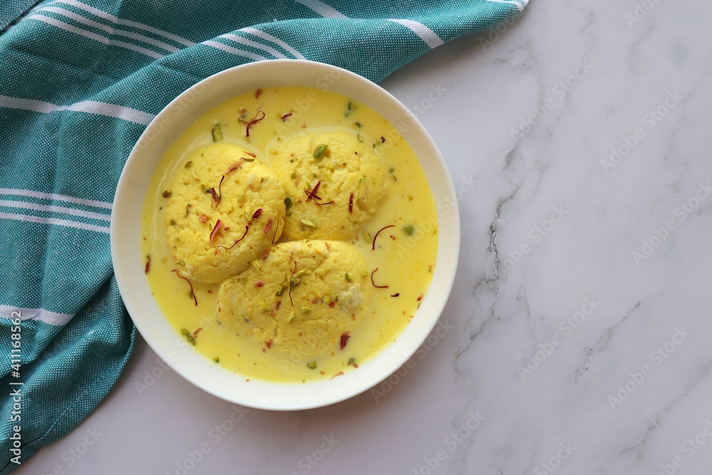 Rasmalai, Rossomalai, Roshmolai, Rasamalei is a very popular Indian dessert. It's a Similar dish to Rasgulla. It is a sweet delicacy made with Indian cottage cheese or chenna. Copy space.