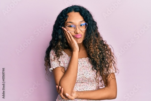 Young latin woman wearing casual clothes and glasses thinking looking tired and bored with depression problems with crossed arms.