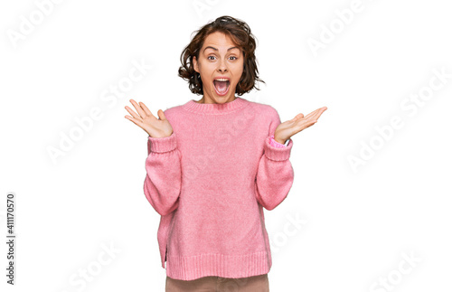 Young hispanic woman wearing casual clothes celebrating crazy and amazed for success with arms raised and open eyes screaming excited. winner concept