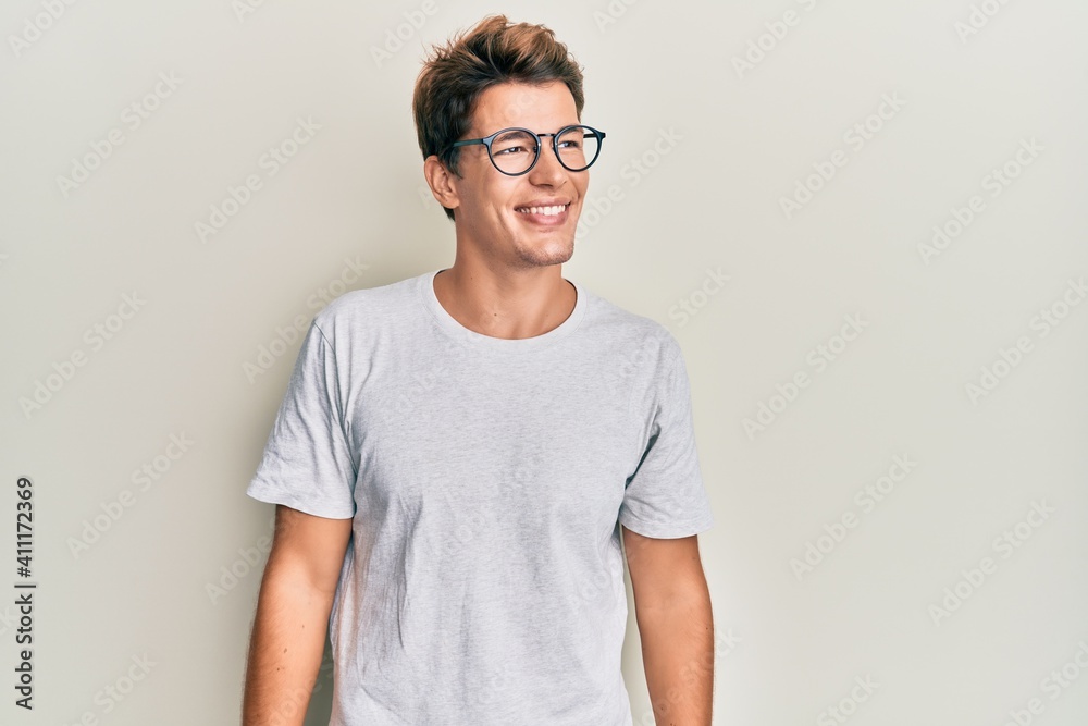 Handsome caucasian man wearing casual clothes and glasses looking to side, relax profile pose with natural face and confident smile. Handsome caucasian man wearing casual clothes and glasses looking to side, relax profile pose with natural face and confident smile.