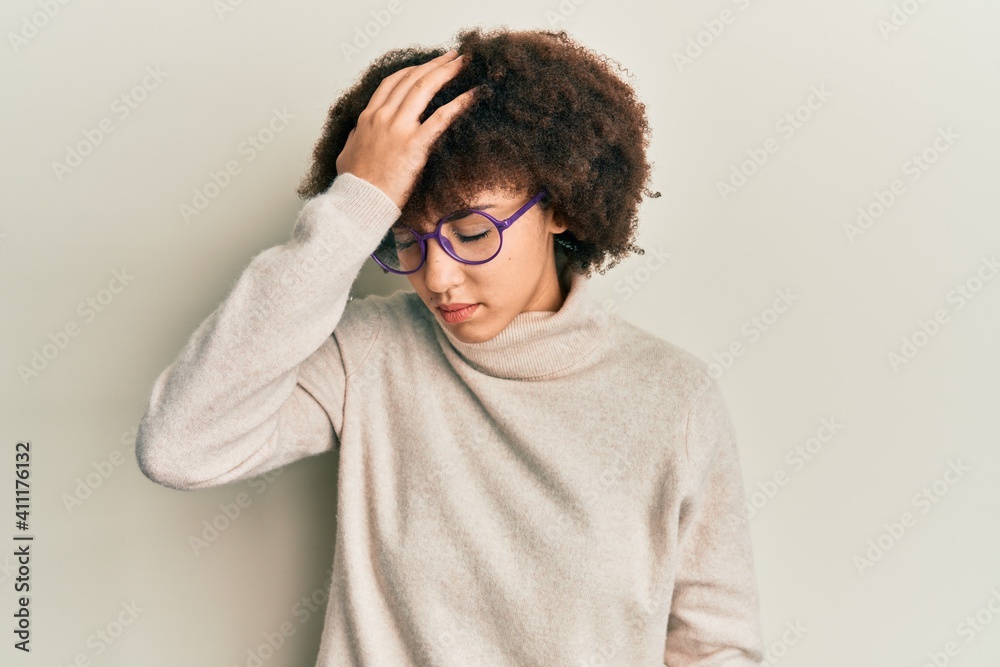 Young hispanic girl wearing casual clothes and glasses surprised with hand on head for mistake, remember error. forgot, bad memory concept. Young hispanic girl wearing casual clothes and glasses surprised with hand on head for mistake, remember error. forgot, bad memory concept.