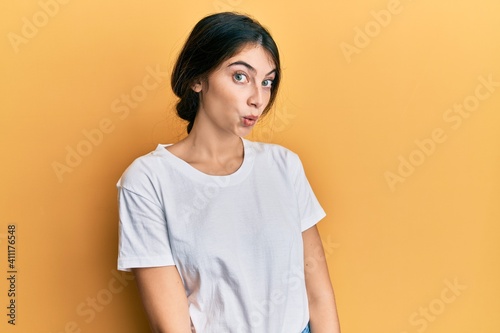 Young caucasian woman wearing casual white t shirt scared and amazed with open mouth for surprise, disbelief face © Krakenimages.com
